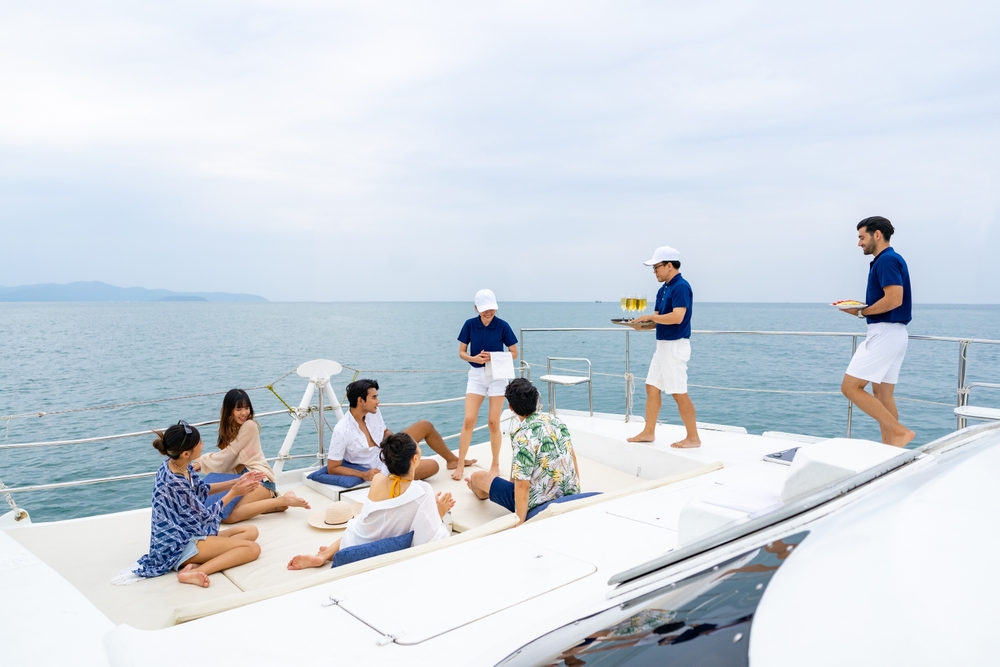 Yacht Crew serving drinks to guests on board | CrewPass